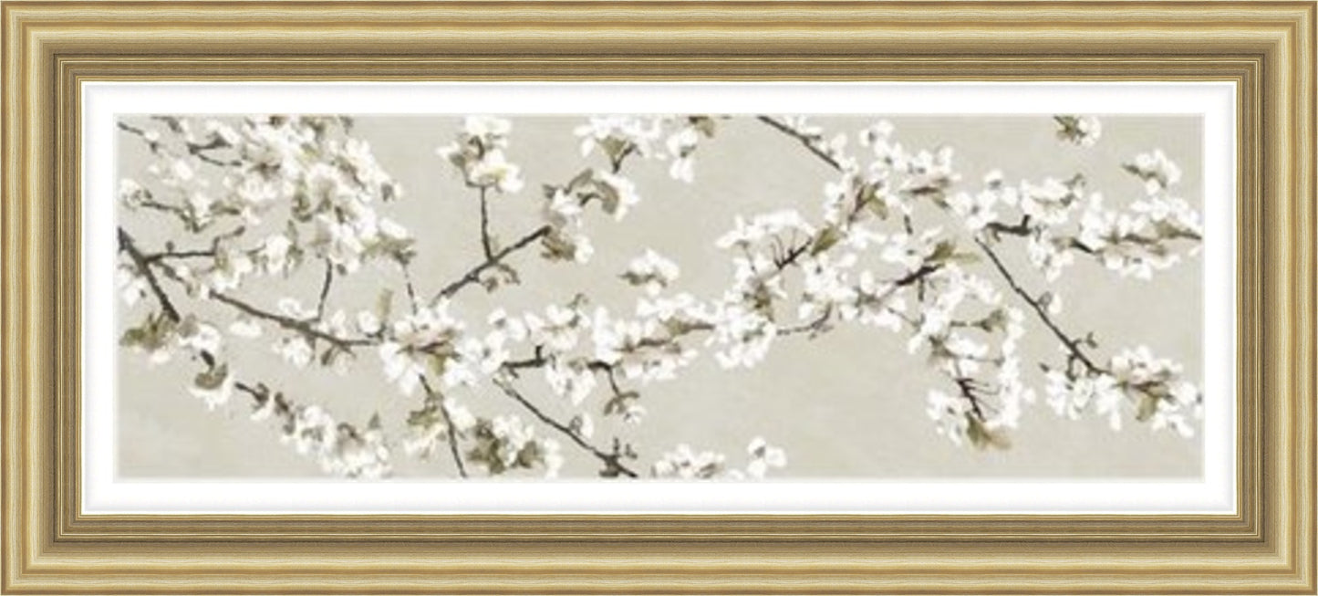 Confetti Blossom by Tania Bello panoramic framed wall art print featuring white flowering branches against a warm taupe-grey neutral background, shown in Antique Gold frame